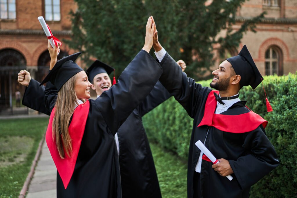 Three happy international graduate friends greeting in universit